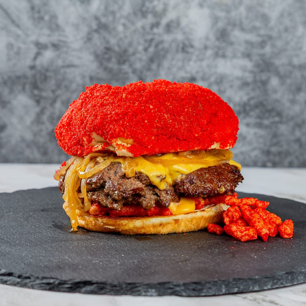 Rodeo Burgers and Chicken's double patty burger with melted cheese, caramelized onions, and a red crunchy bun.