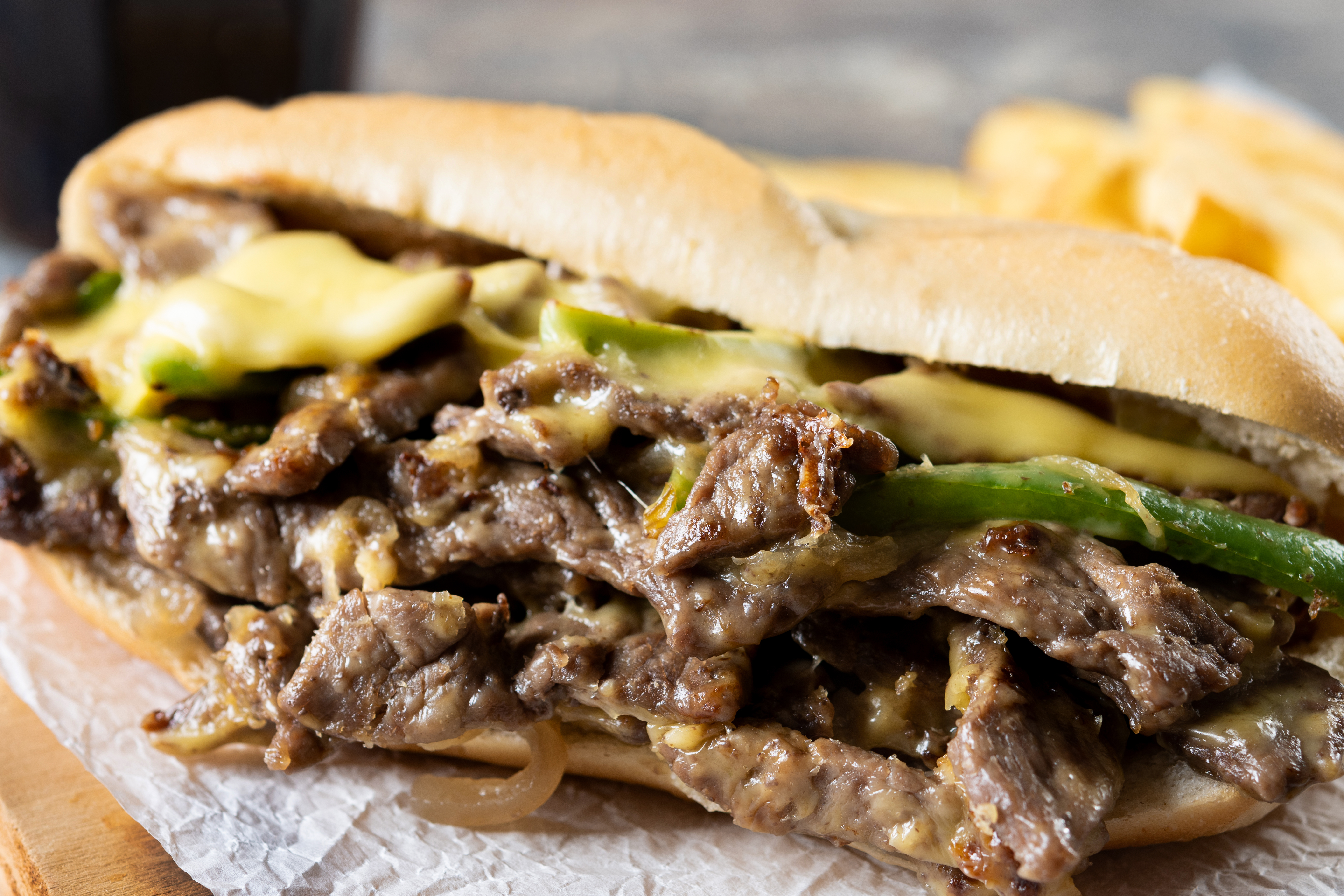 Philly cheesesteak sandwich on wooden table