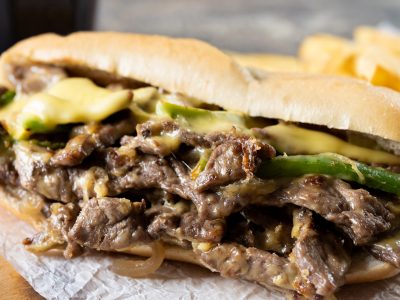 Philly cheesesteak sandwich on wooden table